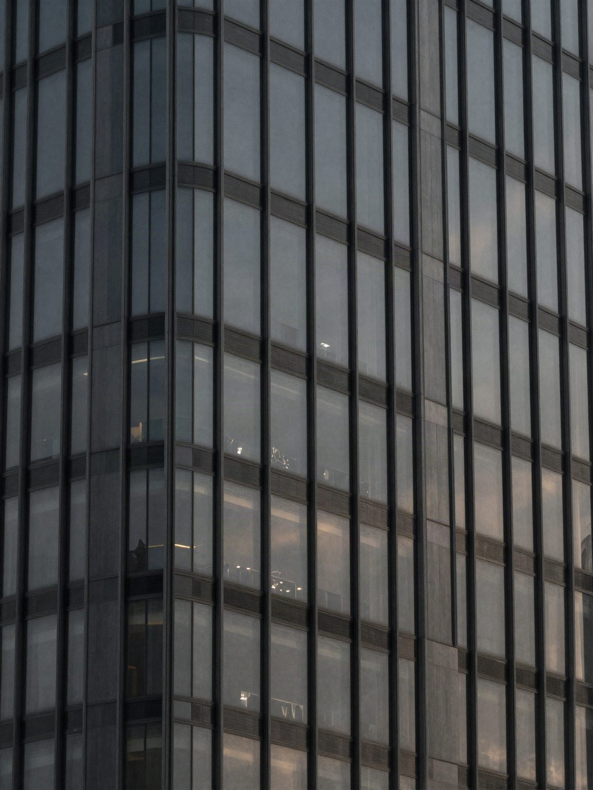 Glass skyscraper facade at dusk
